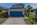 Attractive home featuring a blue garage door, stone accents, landscaping and well maintained lawn at 6222 Trent Creek Dr, Sun City Center, FL 33573