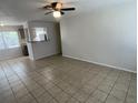 Open-concept living room with tile flooring and open to the kitchen with a bar at 6411 26Th W St, Bradenton, FL 34207