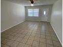 Bright living room with tile flooring, a ceiling fan, and natural light from the window at 6411 26Th W St, Bradenton, FL 34207