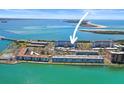 Aerial view showcases the real estate's location on the water with nearby amenities at 7 Elgin Pl # 510, Dunedin, FL 34698