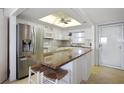 Bright kitchen featuring stainless steel appliances, granite countertops, and a stylish island with seating at 7 Elgin Pl # 510, Dunedin, FL 34698