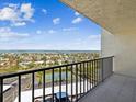 Balcony view overlooking tennis courts, parking, and sparkling bay waters at 736 Island Way # 1101, Clearwater Beach, FL 33767