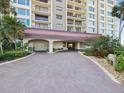 Elegant condo entrance with porte cochere and lush landscaping at 736 Island Way # 1101, Clearwater Beach, FL 33767