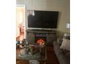 Living room showcasing decorative fireplace, television, and comfortable seating area at 7435 46Th N Ave, St Petersburg, FL 33709