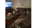 Cozy living room features a sectional sofa, modern decor, and a decorative fireplace at 7435 46Th N Ave, St Petersburg, FL 33709