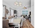 Open-concept dining area connected to the living room, featuring modern furniture and ample natural light at 811 College Leaf Way, Ruskin, FL 33570
