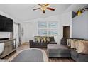 Comfortable living room with stylish gray sofas, patterned rug, and coastal-themed artwork, perfect for relaxation at 811 College Leaf Way, Ruskin, FL 33570