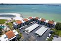 Aerial view of a condo complex with beach access and beautiful ocean views on a sunny day at 825 S Gulfview Blvd # 202, Clearwater Beach, FL 33767