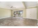 The living room features tile flooring, large window, and a modern ceiling fan at 8302 W Pocahontas Ave, Tampa, FL 33615