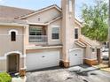 Attractive exterior view of a townhome with a balcony and an attached garage at 10434 Villa View Cir, Tampa, FL 33647