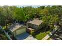 Charming home features a detached garage, private fenced yard, and mature trees, offering a serene living environment at 1155 Withlacoochee St, Safety Harbor, FL 34695