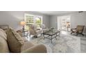 Comfortable living room with neutral tones, plush seating, and ample natural light at 1211 S Druid Ln, Tampa, FL 33629