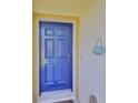 A close up view of the bright blue front door with a 'Welcome' sign at 1216 Lyndhurst Greens Dr, Sun City Center, FL 33573