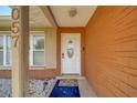 Inviting entryway showcasing the front door with decorative glass and a welcoming mat at 13057 89Th Ave, Seminole, FL 33776