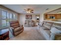 Spacious living room featuring neutral walls, a ceiling fan, and comfortable furnishings at 13057 89Th Ave, Seminole, FL 33776