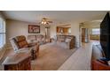 Comfortable living room with plush seating, ceiling fan, and an open layout flowing into the kitchen at 13057 89Th Ave, Seminole, FL 33776