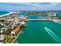 Panoramic aerial view of a coastal neighborhood near a vibrant waterfront and beach at 135 92Nd Ave # 2, Treasure Island, FL 33706