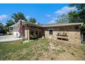 Single-story brick home with a two-car garage and well kept yard at 1399 Leeward Ave, Spring Hill, FL 34606