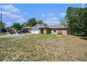 Charming single-story home with brick facade, two-car garage, and traditional lawn at 1399 Leeward Ave, Spring Hill, FL 34606