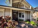 Home entrance featuring a wood door, stone walkway, and manicured garden at 14678 Village Glen Cir, Tampa, FL 33618