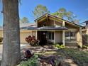 Inviting home entrance showcasing a brick walkway, well-maintained landscaping, and natural lighting at 14678 Village Glen Cir, Tampa, FL 33618