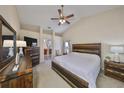 Spacious main bedroom featuring a ceiling fan, a wooden bed frame, and plenty of natural light at 2004 Berry Roberts Dr, Sun City Center, FL 33573