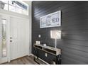 Stylish entryway featuring a shiplap accent wall, console table, and decorative accents, creating a warm welcome at 20203 Merry Oak Ave, Tampa, FL 33647