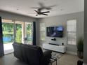 Bright living room with a sliding glass door to a patio and a beautiful lake view at 2111 Park Crescent Dr, Land O Lakes, FL 34639