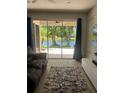 Lovely patio with lake view, accessible from the living room through sliding glass doors at 2111 Park Crescent Dr, Land O Lakes, FL 34639