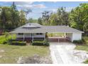Charming home featuring a covered carport, and well-maintained lawn and landscaping at 2231 Nichols Rd, Lithia, FL 33547