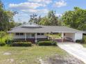 Charming home featuring a covered carport, and well-maintained lawn and landscaping at 2231 Nichols Rd, Lithia, FL 33547
