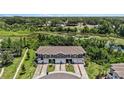 Aerial view showcasing the townhome community's proximity to lush greenery and serene water features at 23378 Papyrus Way, Lutz, FL 33549
