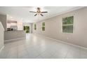 Bright and airy living room with tile flooring and multiple windows offering abundant natural light at 23378 Papyrus Way, Lutz, FL 33549