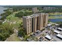 Aerial view of condominium building overlooking the golf course, pond, and adjacent community at 2616 Cove Cay Dr # 803, Clearwater, FL 33760