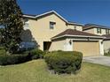 Two-story house with a well-kept lawn, landscaping, and a two-car attached garage at 32111 Brookstone Dr, Wesley Chapel, FL 33545