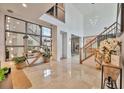 Bright and spacious foyer with high ceilings, staircase, contemporary decor, and marble flooring at 32324 Rosewood Meadow Ln, Wesley Chapel, FL 33543