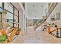 Grand two-story foyer with marble floors, staircase, modern lighting, and elegant decor at 32324 Rosewood Meadow Ln, Wesley Chapel, FL 33543