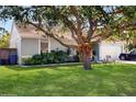 A mature oak tree creates shade in the front yard of this home with manicured landscaping at 3238 6Th W Ave, Palmetto, FL 34221