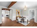 The dining room features a round table and white chairs, with wood flooring and decorative beam and light fixture at 4003 W Lemon St, Tampa, FL 33609