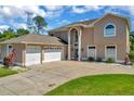 Stunning two-story home with an attached three-car garage and large driveway at 4612 Netherwood Dr, Tampa, FL 33624