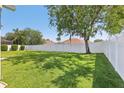 Spacious backyard featuring a lush lawn, mature trees, and a privacy fence at 5119 Whispering Leaf Trail, Valrico, FL 33596
