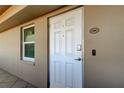 View of front door with digital entry lock, number 204, and adjacent window at 5200 Brittany S Dr # 204, St Petersburg, FL 33715