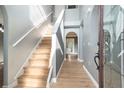 Inviting foyer with light wood flooring, staircase, and light gray walls, creating a modern entryway at 5410 Treig Ln, Wesley Chapel, FL 33545