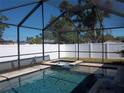 Inviting screened-in pool and spa area with privacy fence at 5413 S Martin Ave, Tampa, FL 33611