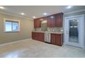 Bright kitchen featuring recessed lighting, wood cabinets, granite countertops, tile flooring, and stainless steel appliances at 5449 Manatee Point Dr, New Port Richey, FL 34652