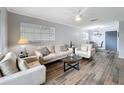 Bright living room boasts updated flooring and neutral paint, with a view of the dining area at 5509 Fountain Lake Cir # C209, Bradenton, FL 34207