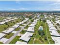 Expansive aerial view of a well-maintained community with lush landscaping and clear blue skies at 6524 11Th W Ave # 5611, Bradenton, FL 34209