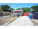 Cozy single-story home with a charming front porch and a spacious driveway at 6812 E 21St Ave, Tampa, FL 33619