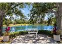 Scenic backyard view featuring a serene lake and lush landscaping, creating a tranquil outdoor oasis at 7303 Westminster Ct, University Park, FL 34201