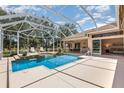 Enclosed pool area with patio and outdoor seating, perfect for entertaining and enjoying the Florida lifestyle at 7303 Westminster Ct, University Park, FL 34201